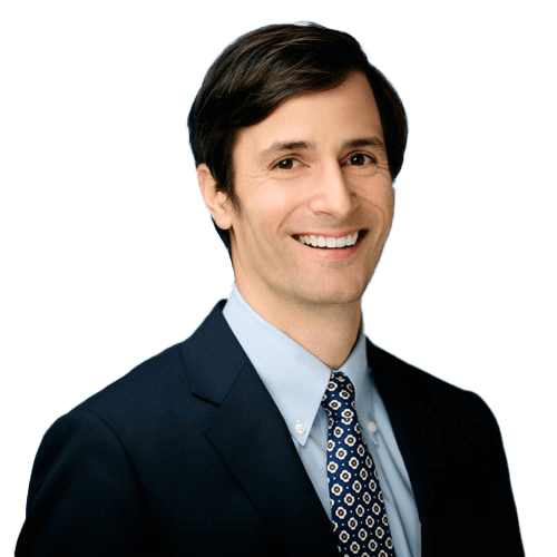 A smiling man in a suit and tie.