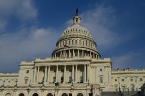 The capitol building is white and green.